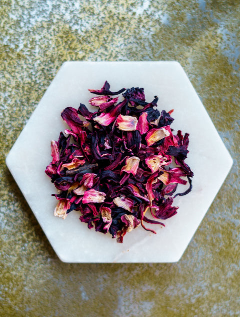 Hibiscus tea herbs on a white plate.