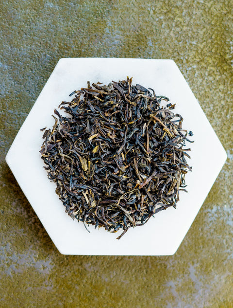 Jasmine tea herbs on a white plate.